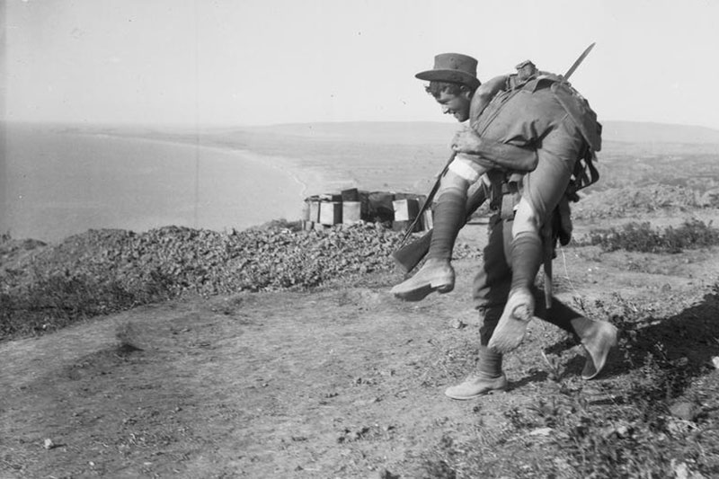 Image: Imperial War Museum | Australian solider carrying a wounded comrade to a medical aid post - Gallipoli 1915